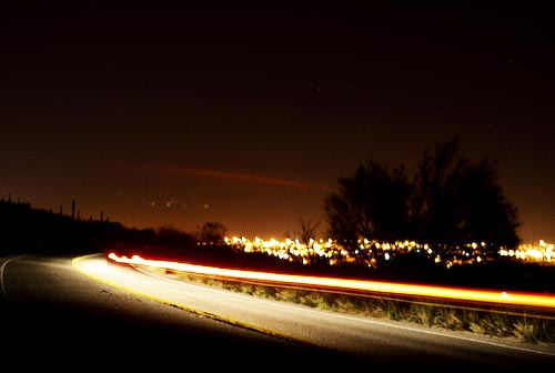Light streams across a midnight road through the west side of Interstate 10.